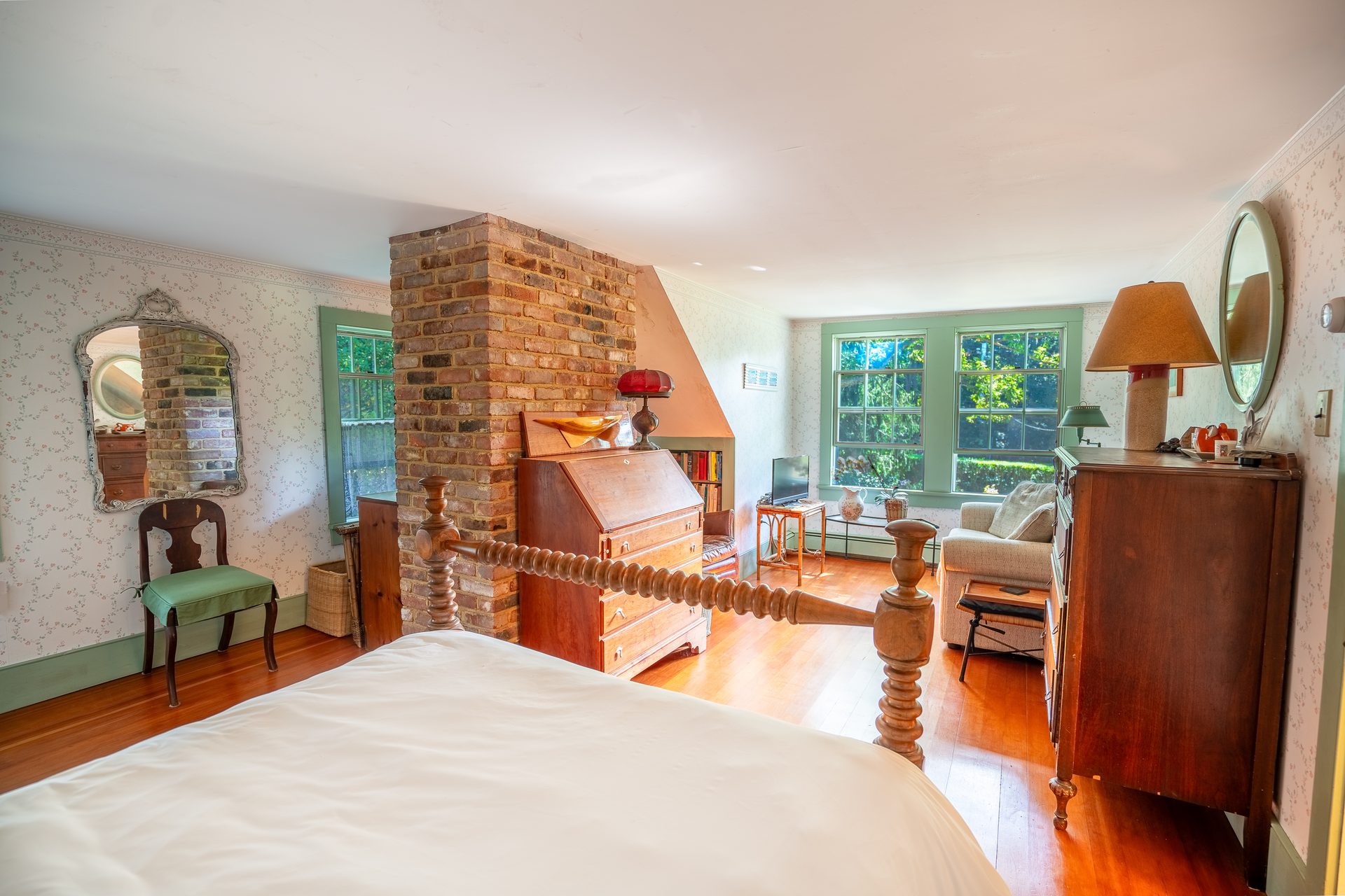 Bedroom with original brick chimney passing through