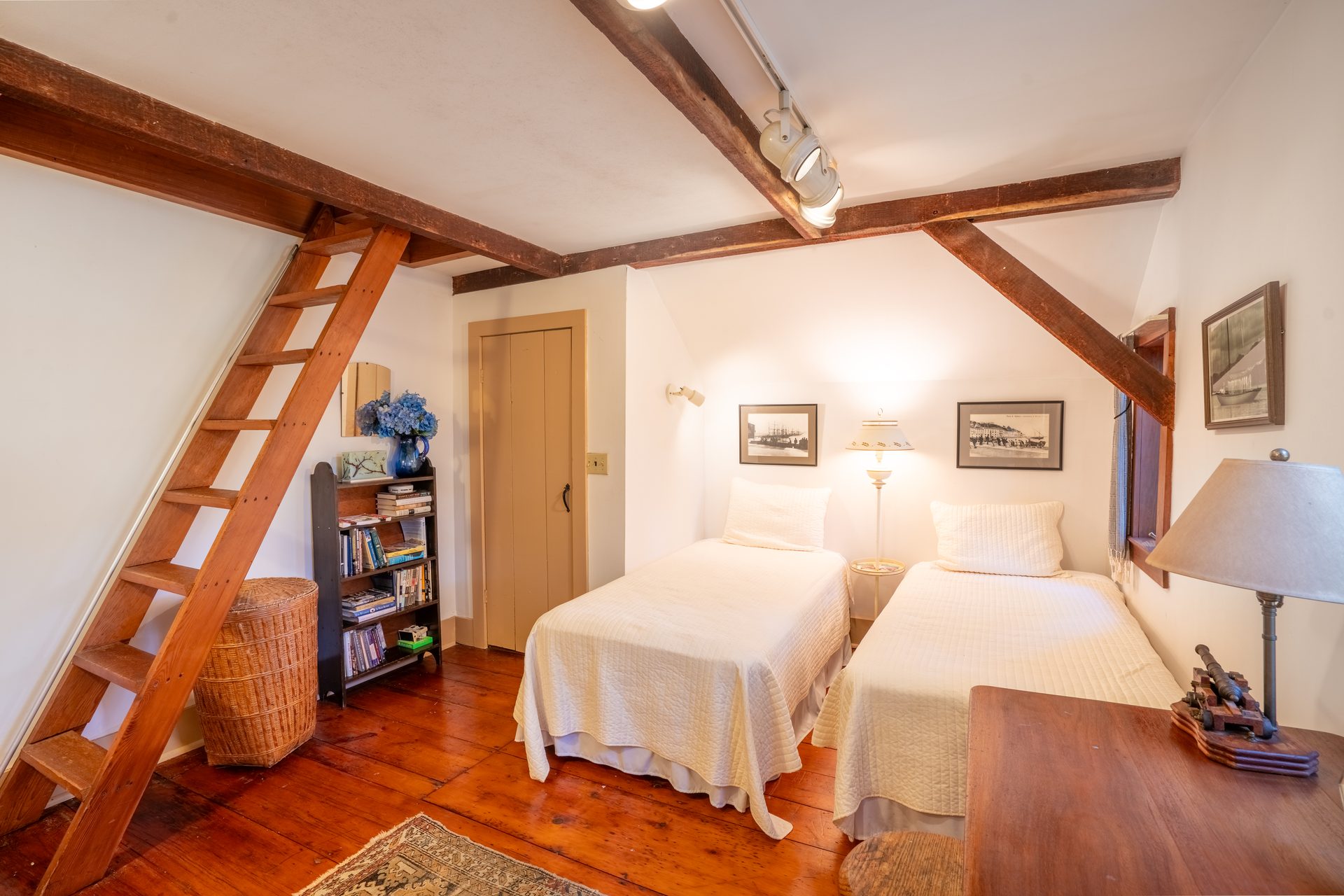 Loft bedroom with hand-hewn rafters