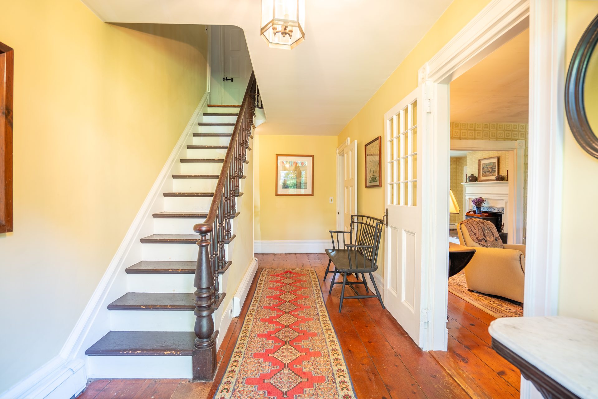 Center stair hall with original wide-plank floors