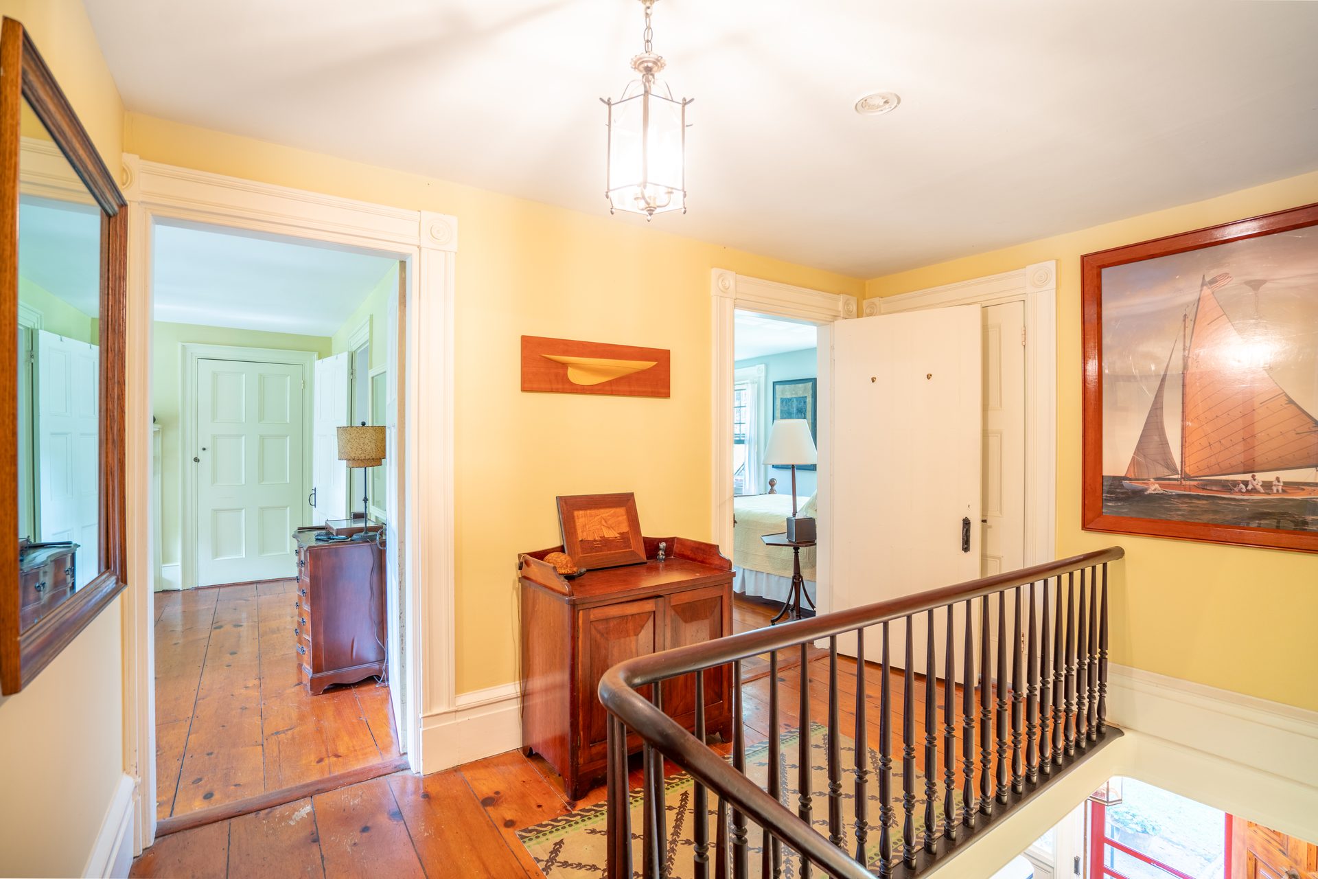 Upstairs hall with painting and original floors